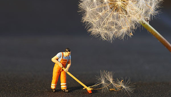 a man holding a floor brush cleaning