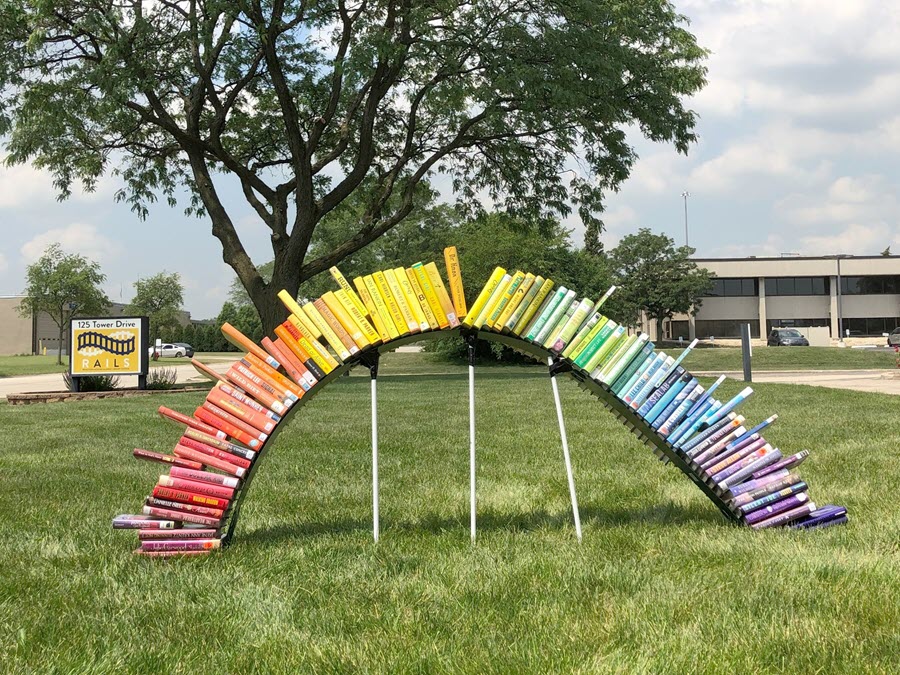 Photo of books outside in the rainbow colored and shaped arc