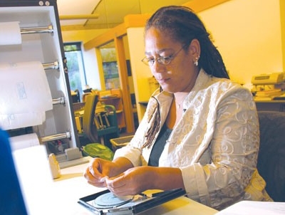 Take advantage of our expertise Woman cataloging a DVD