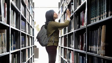 Library user browsing shelves