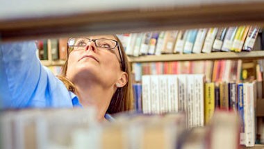 Staffer reshelving books