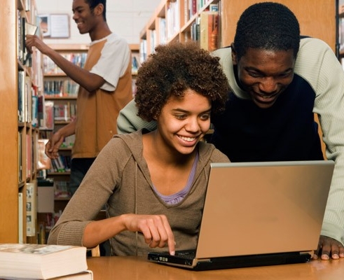 Students searching for books in library