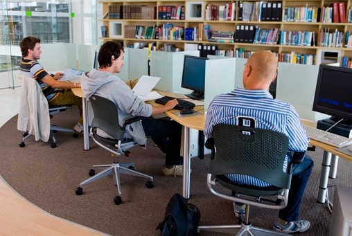 Students using computers in library