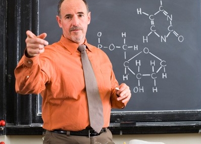 Male professor in front of chalkboard