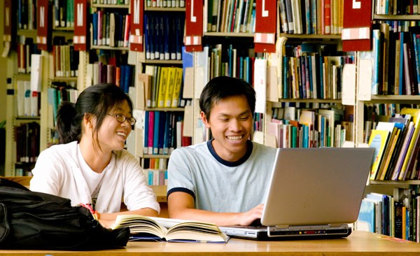 Two students working in the library