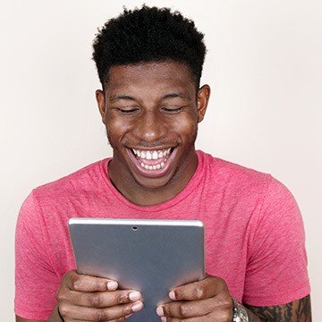 Photo: Man using tablet Photo: Man using tablet