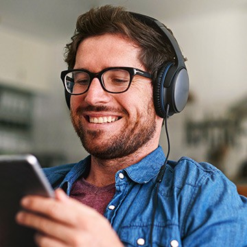 Photo: Man watching video on tablet Photo: Man watching video on tablet