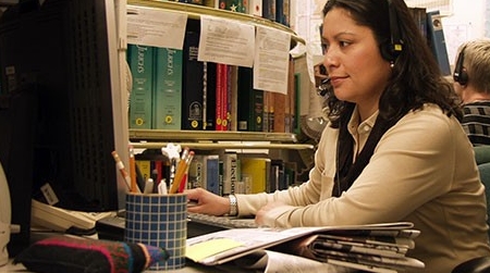 Librarian working on computer Female librarian working on computer