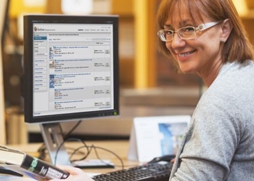Librarian using WorldShare Acquisitions on computer Female librarian using WorldShare Acquisitions on computer