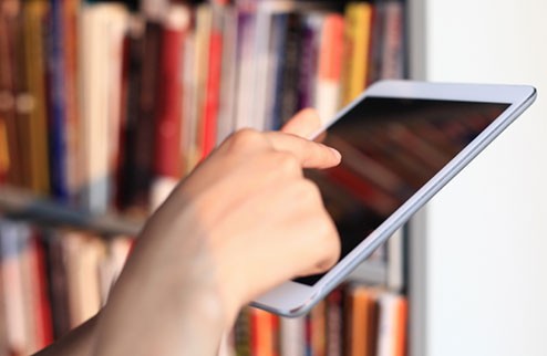 Person using a tablet in a library