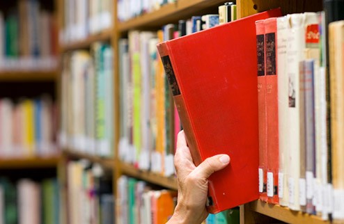 Librarian reshelving a book Librarian reshelving a book